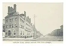  Four-story stone building on the left, unpaved street on the right
