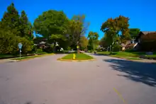 A view of Kensington Boulevard northward from its intersection with Nevada Avenue in the Kensington Boulevard Historic District. Kensington is divided by planted esplanades (central reservations) along its entire length through the district.