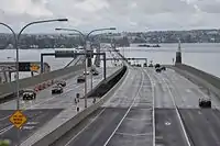 A long floating bridge crossing a lake in a suburban area