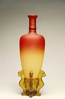 beautiful vase with consisting of red glass at top that fades to off-white at bottom