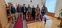 Adam Słomka amidst soldiers and officers of the Ukrainian Army in Kiev 2022