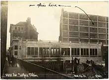 A one-story concrete structure and a seven-story office building