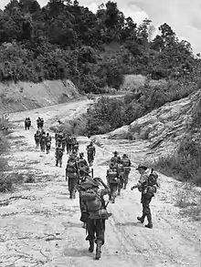 Soldiers advance down a road