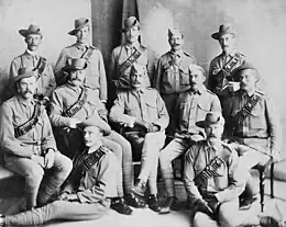 a black and white group portrait of twelve men in uniform