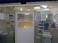 Pharmacy where the door has been replaced with a hatch for exchanging goods.