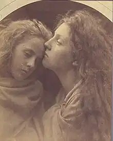 A woman's cheek rests on the forehead of a younger girl. Both appear calm and are draped in fabric from the neck down.
