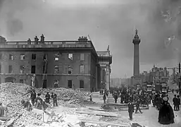 Black-and-white photograph of The Pillar surrounded by ruins of destroyed buildings