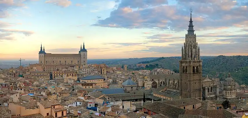 A cityscape; two tall buildings dominate the view, the Alcázar and the Cathedral.