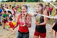 People throwing water over each other